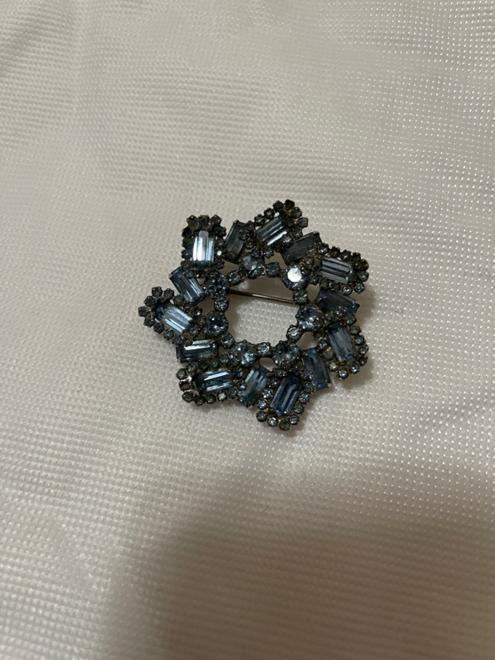 Blue gem brooch patina